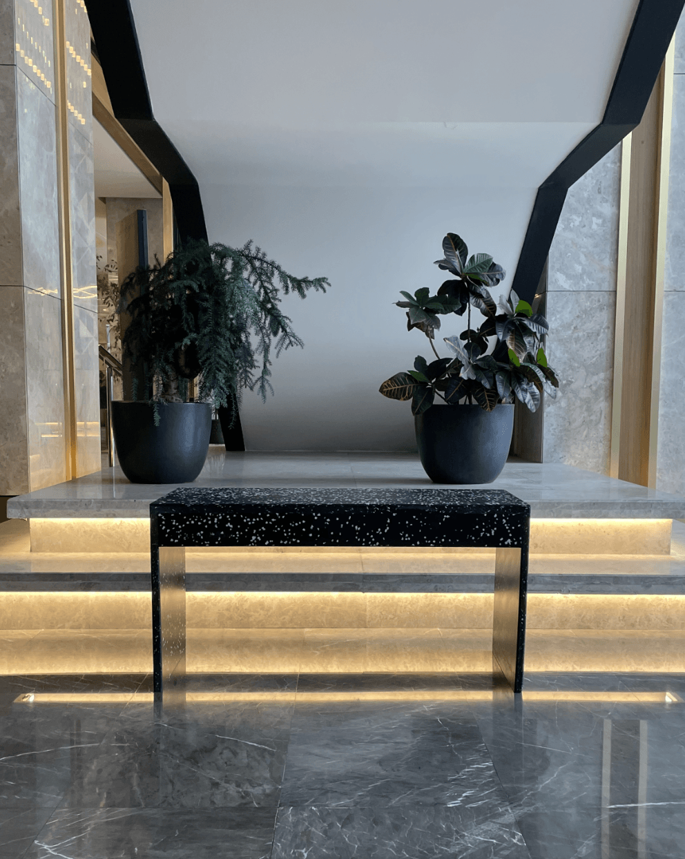 Lobby · custom terrazzo console on illuminated steps